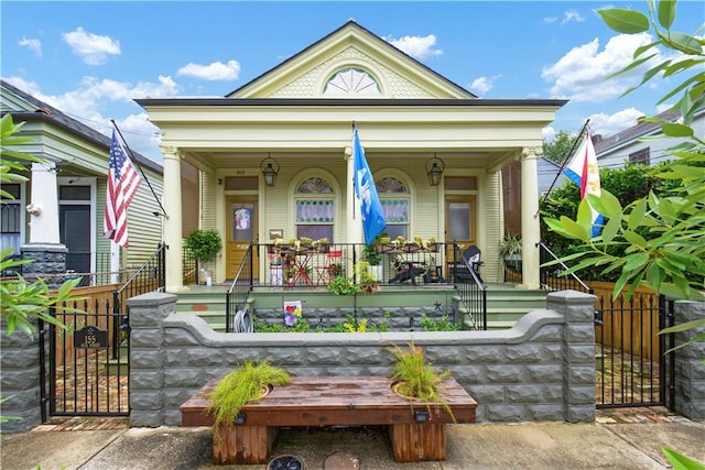 155 Alix St, New Orleans, LA 70114 - view of front of home with covered porch, a gate, and a fenced front yard