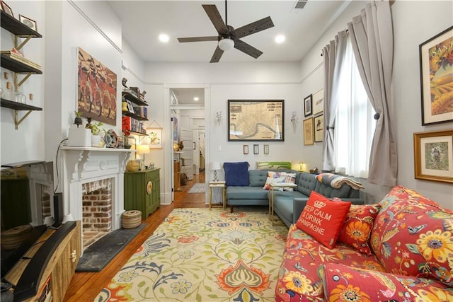 155 Alix St, New Orleans, LA 70114 - living room featuring wood finished floors, ceiling fan, a brick fireplace, and recessed lighting