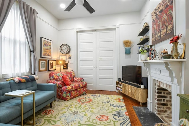 155 Alix St, New Orleans, LA 70114 - living room with ceiling fan, wood finished floors, and a brick fireplace