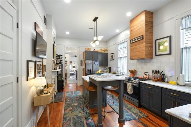 155 Alix St, New Orleans, LA 70114 - kitchen with appliances with stainless steel finishes, dark wood-style flooring, decorative backsplash, a sink, and recessed lighting