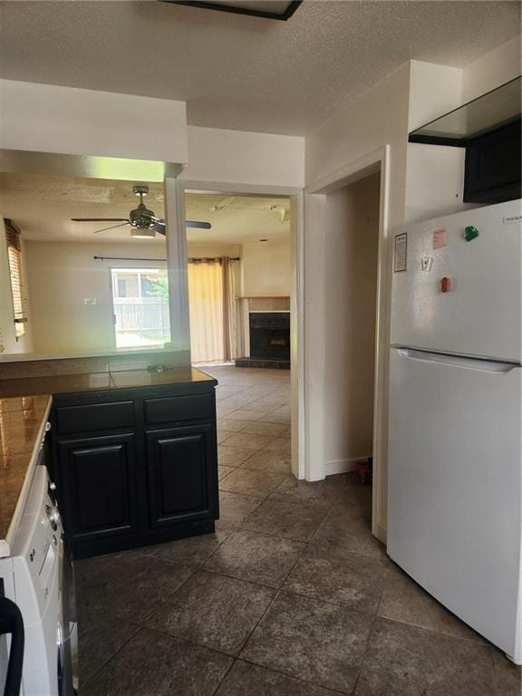 3711 Brandywine Dr Unit 3711, Metairie, LA 70002 - kitchen with freestanding refrigerator, a ceiling fan, dark countertops, plenty of natural light, and a textured ceiling