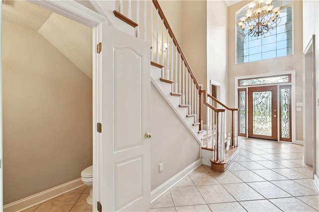 4908 Avron Blvd, Metairie, LA 70006 - entrance foyer with a chandelier, light tile patterned floors, stairway, and high vaulted ceiling