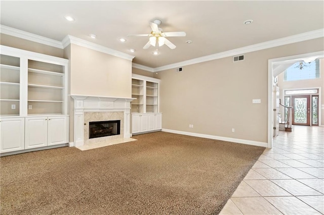 4908 Avron Blvd, Metairie, LA 70006 - unfurnished living room featuring ceiling fan, a fireplace, light tile patterned floors, light carpet, and crown molding