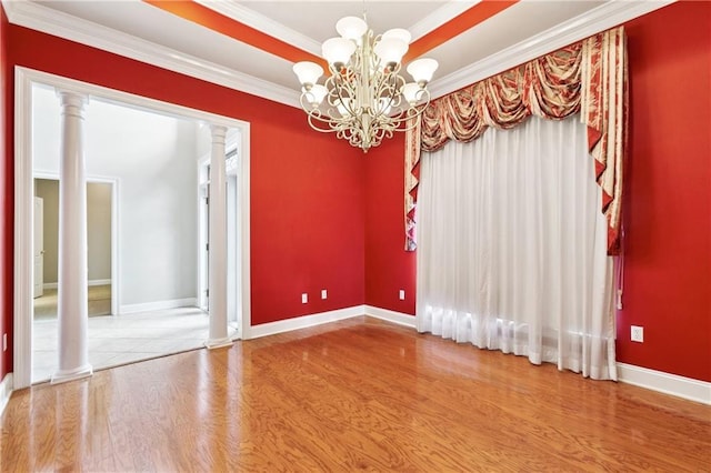 4908 Avron Blvd, Metairie, LA 70006 - spare room featuring a chandelier, wood finished floors, decorative columns, crown molding, and baseboards