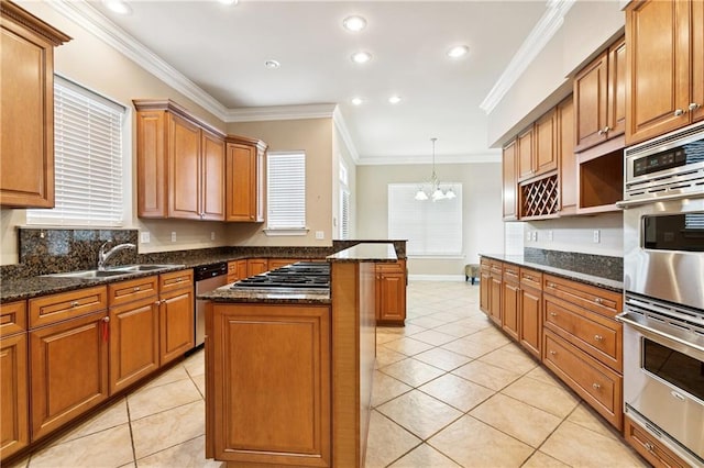 4908 Avron Blvd, Metairie, LA 70006 - kitchen with stainless steel appliances, light tile patterned floors, ornamental molding, a chandelier, and a peninsula