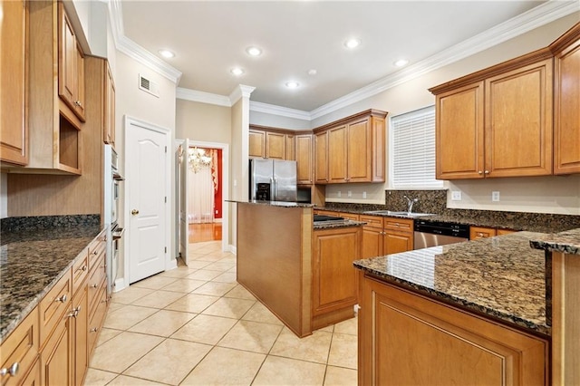 4908 Avron Blvd, Metairie, LA 70006 - kitchen featuring stainless steel appliances, ornamental molding, light tile patterned flooring, brown cabinets, and dark stone counters