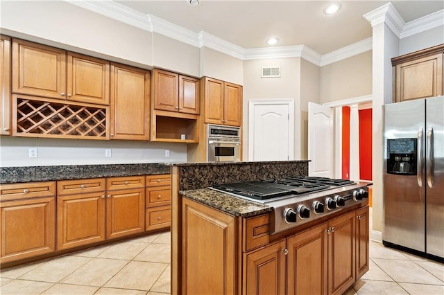 4908 Avron Blvd, Metairie, LA 70006 - kitchen featuring stainless steel appliances, light tile patterned flooring, a kitchen island, ornamental molding, and dark stone counters
