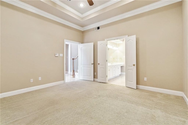 4908 Avron Blvd, Metairie, LA 70006 - unfurnished bedroom with crown molding, light carpet, a tray ceiling, ensuite bath, and a ceiling fan