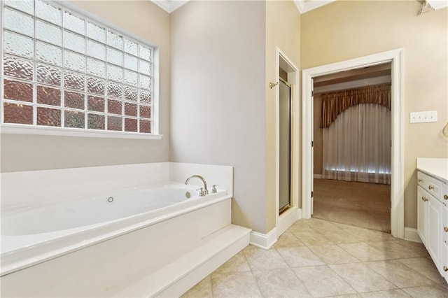 4908 Avron Blvd, Metairie, LA 70006 - bathroom with a garden tub, vanity, a shower stall, tile patterned floors, and baseboards