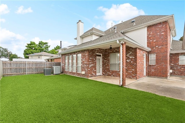 4908 Avron Blvd, Metairie, LA 70006 - back of property with a chimney, a shingled roof, brick siding, and a patio area