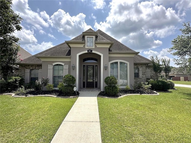 667 Highlands Dr, Slidell, LA 70458 - french country inspired facade featuring stucco siding, a front yard, and roof with shingles