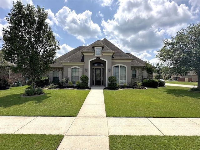 667 Highlands Dr, Slidell, LA 70458 - french provincial home with stucco siding, a front lawn, and roof with shingles