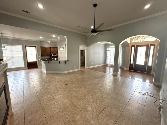 667 Highlands Dr, Slidell, LA 70458 - unfurnished living room featuring arched walkways, light tile patterned flooring, crown molding, recessed lighting, and a ceiling fan