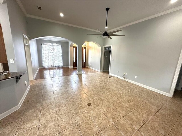 667 Highlands Dr, Slidell, LA 70458 - unfurnished living room featuring arched walkways, ceiling fan, ornamental molding, light tile patterned floors, and recessed lighting