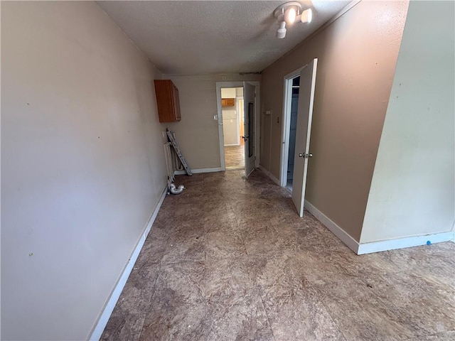 33739 Highway Dr, Jefferson, LA 70121 - corridor with baseboards and a textured ceiling