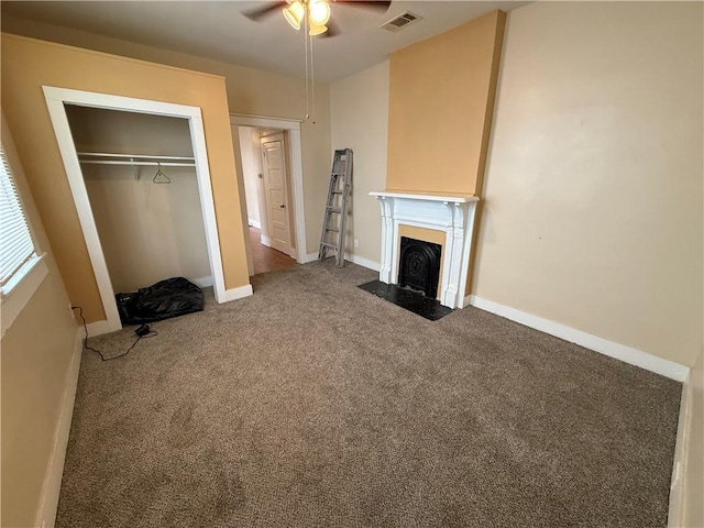 33739 Highway Dr, Jefferson, LA 70121 - unfurnished living room featuring ceiling fan, carpet, a fireplace with flush hearth, and baseboards