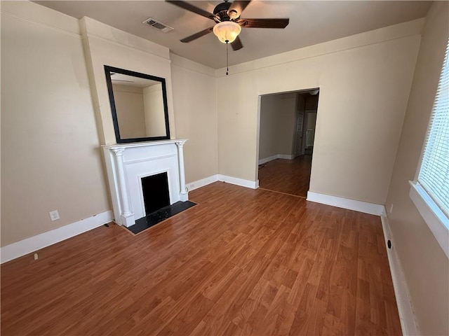 33739 Highway Dr, Jefferson, LA 70121 - unfurnished living room featuring a ceiling fan, baseboards, wood finished floors, and a fireplace with flush hearth
