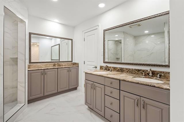 5117 Academy Dr, Metairie, LA 70003 - bathroom with double vanity, a marble finish shower, marble finish flooring, and recessed lighting