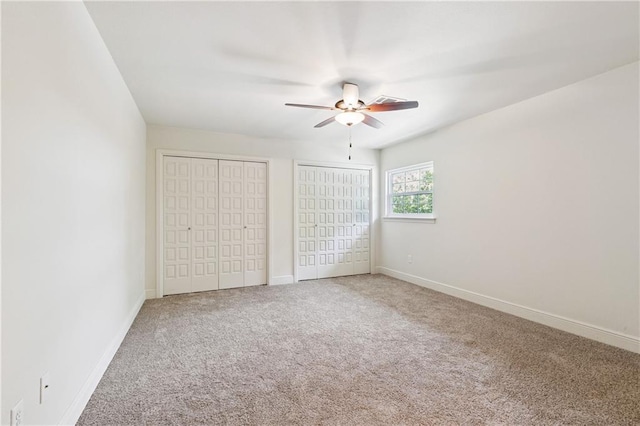 5117 Academy Dr, Metairie, LA 70003 - unfurnished bedroom with multiple closets, carpet flooring, and ceiling fan