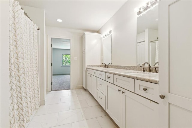 5117 Academy Dr, Metairie, LA 70003 - bathroom featuring double vanity, marble finish floors, and recessed lighting