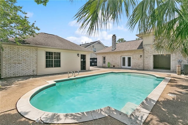 5117 Academy Dr, Metairie, LA 70003 - view of swimming pool featuring french doors and a patio