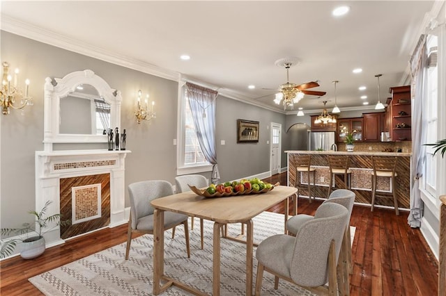 2720 New Orleans St, New Orleans, LA 70119 - dining space featuring a fireplace, a chandelier, recessed lighting, ornamental molding, and a ceiling fan