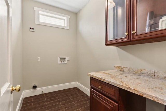 2720 New Orleans St, New Orleans, LA 70119 - laundry area with baseboards, washer hookup, cabinet space, and dark wood finished floors