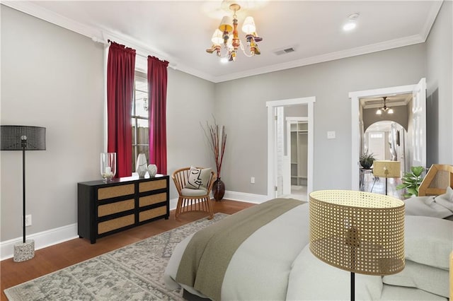 2720 New Orleans St, New Orleans, LA 70119 - bedroom with a chandelier, ornamental molding, wood finished floors, baseboards, and a spacious closet