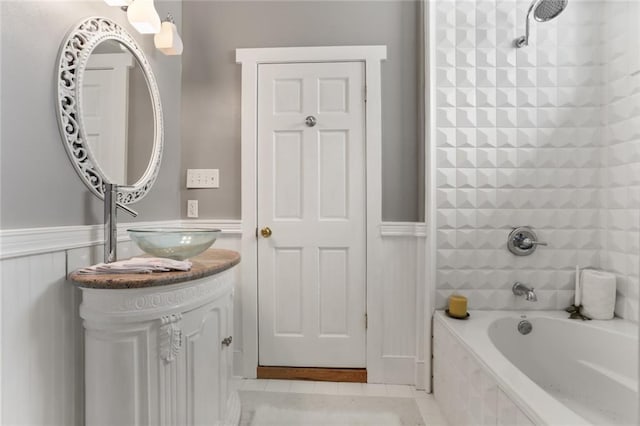 2720 New Orleans St, New Orleans, LA 70119 - full bath with tile patterned floors, vanity, wainscoting, and bathing tub / shower combination