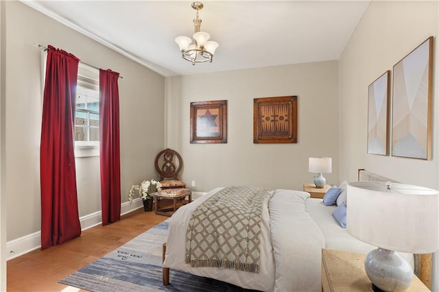 2720 New Orleans St, New Orleans, LA 70119 - bedroom featuring wood finished floors, a chandelier, and baseboards