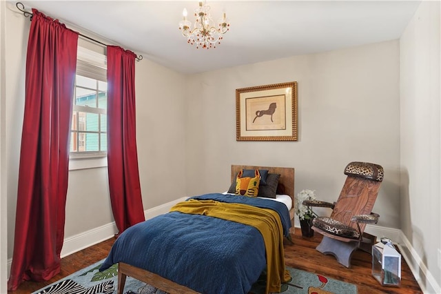 2720 New Orleans St, New Orleans, LA 70119 - bedroom featuring a chandelier, wood finished floors, and baseboards