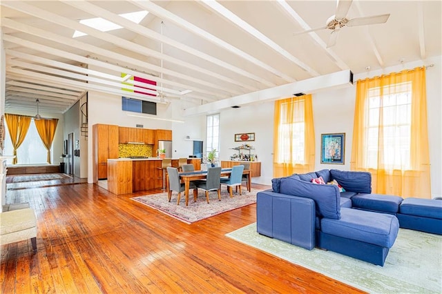 1260 Esplanade Ave Unit 2, New Orleans, LA 70119 - living room featuring hardwood / wood-style flooring, high vaulted ceiling, a ceiling fan, and beam ceiling