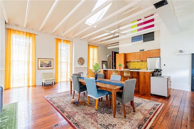 1260 Esplanade Ave Unit 2, New Orleans, LA 70119 - dining room featuring hardwood / wood-style flooring, ceiling fan, beam ceiling, and high vaulted ceiling