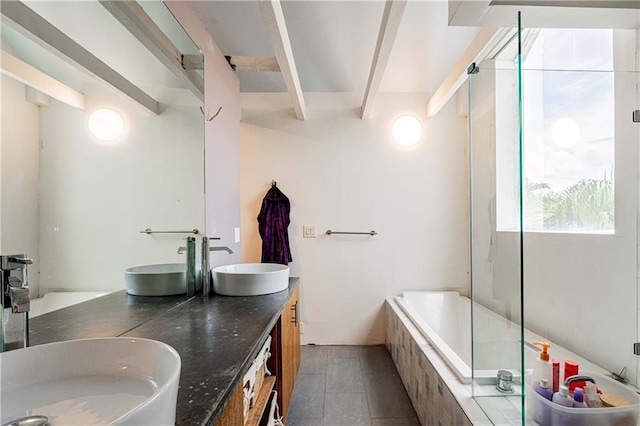 1260 Esplanade Ave Unit 2, New Orleans, LA 70119 - bathroom with beam ceiling, tiled bath, a tile shower, double vanity, and tile patterned flooring