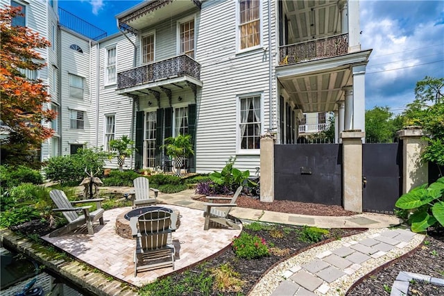 1260 Esplanade Ave Unit 2, New Orleans, LA 70119 - view of patio / terrace with an outdoor fire pit and a balcony
