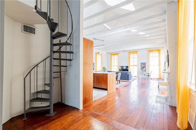 1260 Esplanade Ave Unit 2, New Orleans, LA 70119 - stairs with wood-type flooring, beamed ceiling, and high vaulted ceiling