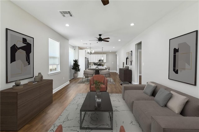 3225 Milan St, New Orleans, LA 70125 - living room featuring a ceiling fan, wood finished floors, recessed lighting, a chandelier, and baseboards