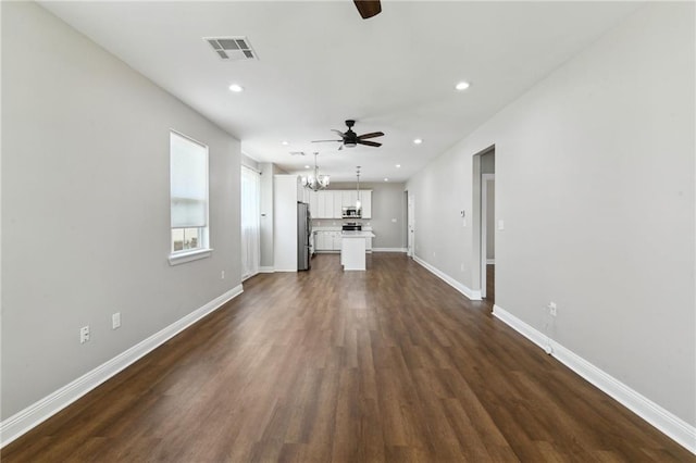 3225 Milan St, New Orleans, LA 70125 - unfurnished living room featuring a ceiling fan, dark wood-style floors, baseboards, recessed lighting, and a chandelier