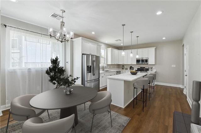 3225 Milan St, New Orleans, LA 70125 - dining room with a chandelier, baseboards, recessed lighting, and dark wood-style flooring