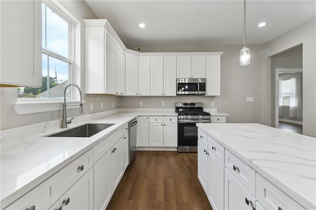 3225 Milan St, New Orleans, LA 70125 - kitchen featuring appliances with stainless steel finishes, a sink, white cabinetry, healthy amount of natural light, and recessed lighting