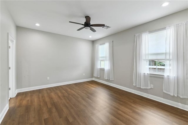 3225 Milan St, New Orleans, LA 70125 - spare room with baseboards, dark wood-type flooring, a ceiling fan, and recessed lighting