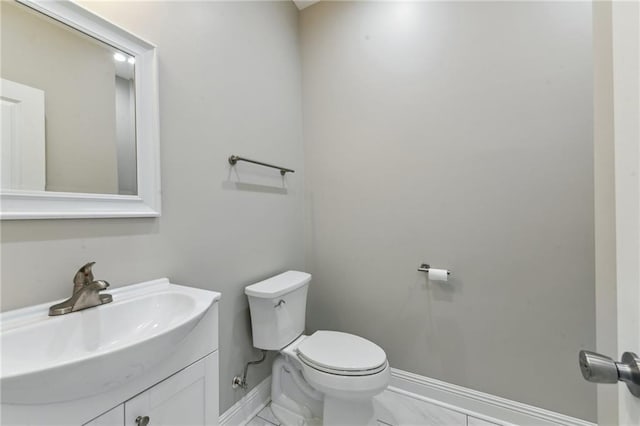 3225 Milan St, New Orleans, LA 70125 - bathroom with toilet, vanity, baseboards, and marble look tiles