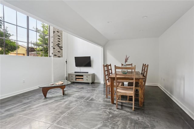 1103 Tchoupitoulas St Unit 102, New Orleans, LA 70130 - dining space featuring baseboards, concrete flooring, and lofted ceiling