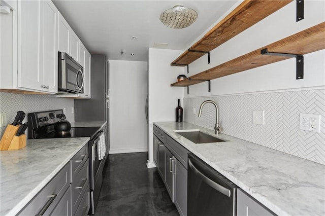 1103 Tchoupitoulas St Unit 102, New Orleans, LA 70130 - kitchen featuring stainless steel appliances, a sink, open shelves, light stone countertops, and decorative backsplash