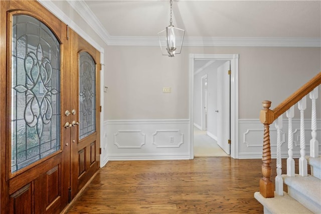 1029 Beverly Garden Dr, Metairie, LA 70002 - foyer entrance with wood finished floors, stairway, a wainscoted wall, and ornamental molding