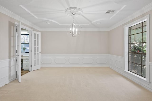 1029 Beverly Garden Dr, Metairie, LA 70002 - empty room featuring a chandelier, plenty of natural light, carpet flooring, wainscoting, and ornamental molding