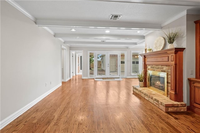 1029 Beverly Garden Dr, Metairie, LA 70002 - unfurnished living room featuring light wood-type flooring, baseboards, beam ceiling, recessed lighting, and a brick fireplace