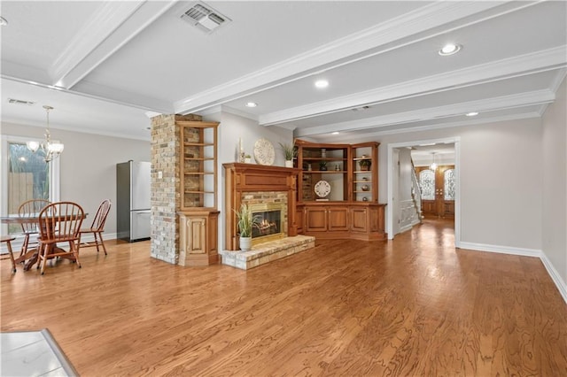 1029 Beverly Garden Dr, Metairie, LA 70002 - living area featuring a chandelier, beam ceiling, crown molding, baseboards, and light wood-type flooring