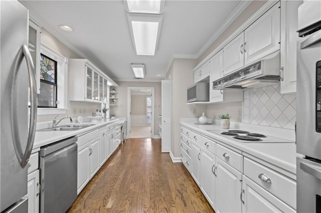 1029 Beverly Garden Dr, Metairie, LA 70002 - kitchen featuring stainless steel appliances, white cabinets, crown molding, extractor fan, and light countertops