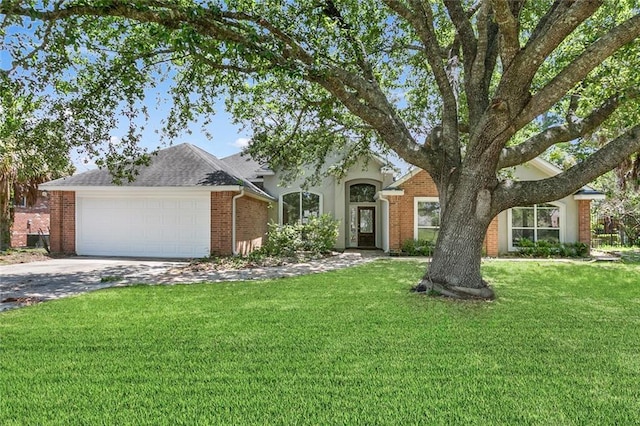 7218 Brookwood Dr, Mandeville, LA 70471 - view of front of home with a garage, a front lawn, concrete driveway, and brick siding